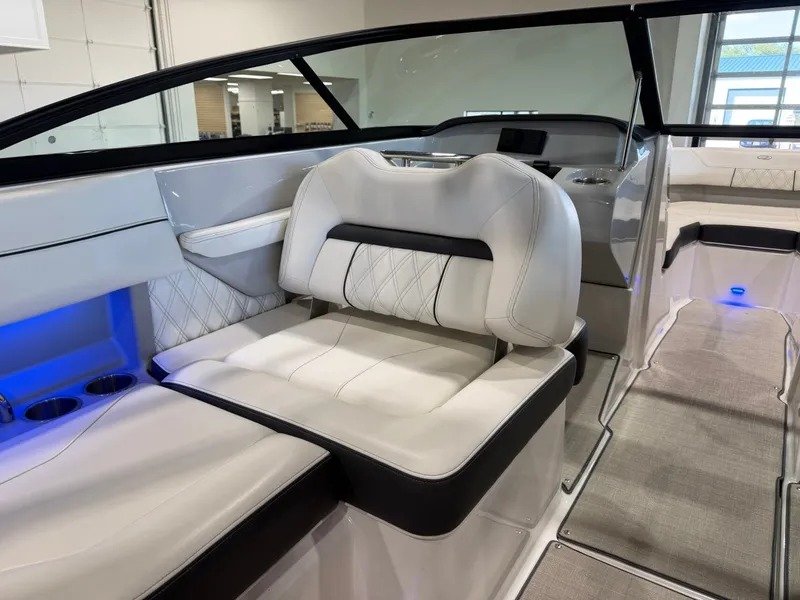 Slide: The Image of Interior of a 2022 Regal LS2 Surf with sleek white seating and blue lighting. - 18