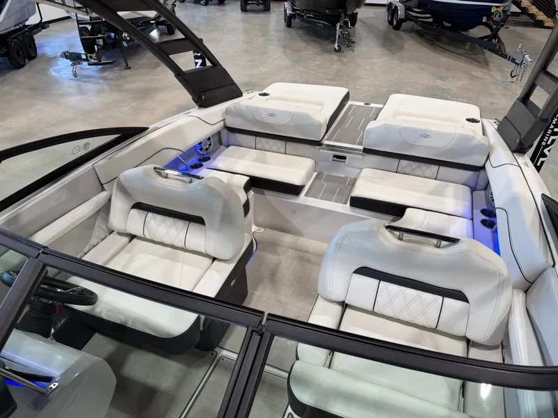 Slide: The Image of The image shows the interior of a 2022 Regal LS2 Surf boat with sleek white seating. - 30