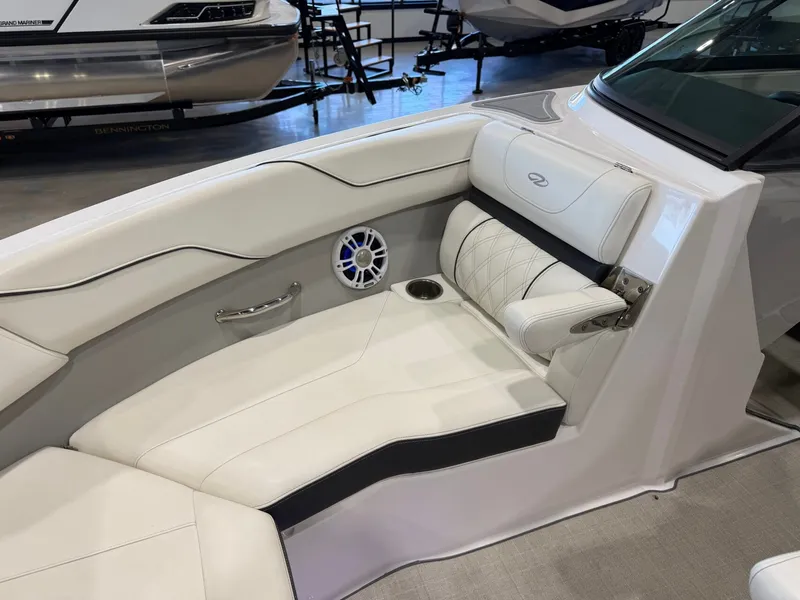 Slide: The Image of The image shows the bow area of a 2022 Regal LS2 Surf boat with white upholstery. - 28