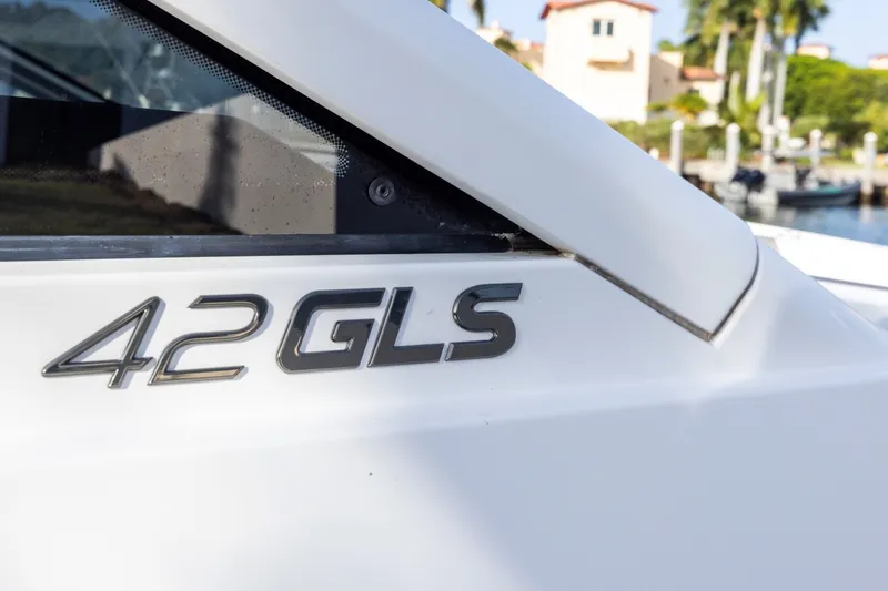 Slide: The Image of 2021 Cruisers Yachts 42 GLS OB logo on white boat exterior. - 27