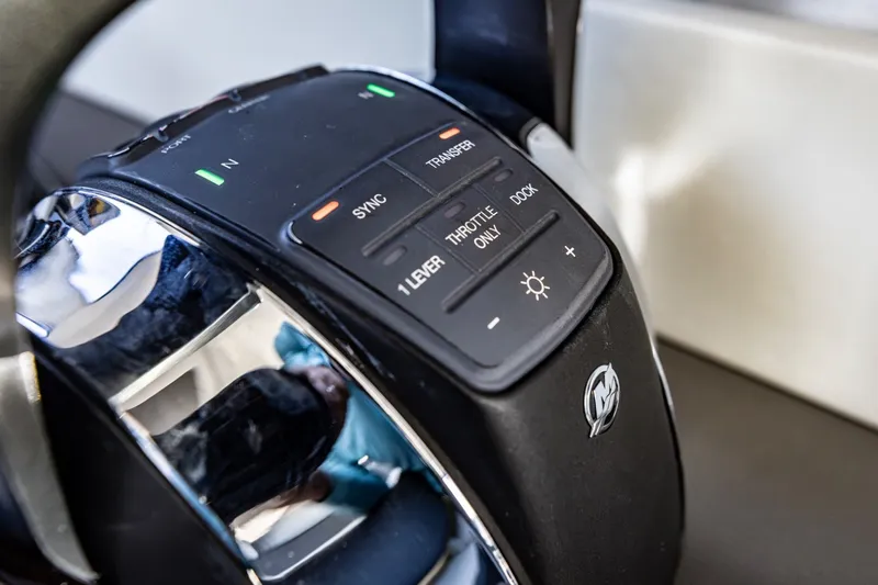 Slide: The Image of Close-up of 2021 Cruisers Yachts 42 GLS OB throttle controls with buttons and indicators. - 14