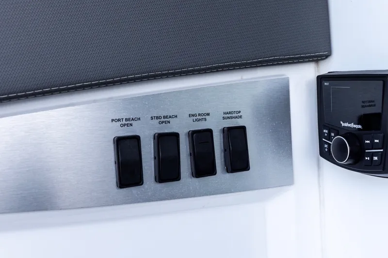 Slide: The Image of Control panel on 2021 Cruisers Yachts 42 GLS OB with labeled switches and audio system. - 30