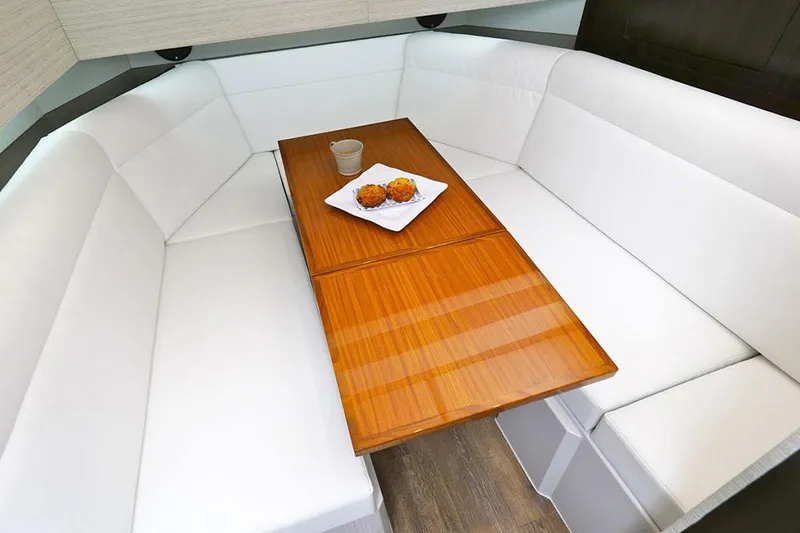 Slide: The Image of Manufacturer Provided Image: Luxurious 2021 Cruisers Yachts 42 GLS interior with elegant white seating and wooden table. - 20