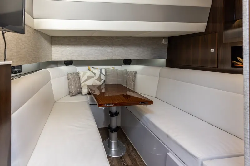 Slide: The Image of Interior of 2021 Cruisers Yachts 42 GLS OB with elegant seating and wooden table. - 19
