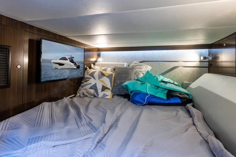 Slide: The Image of Luxurious cabin interior of 2021 Cruisers Yachts 42 GLS OB with cozy bedding and modern decor. - 22