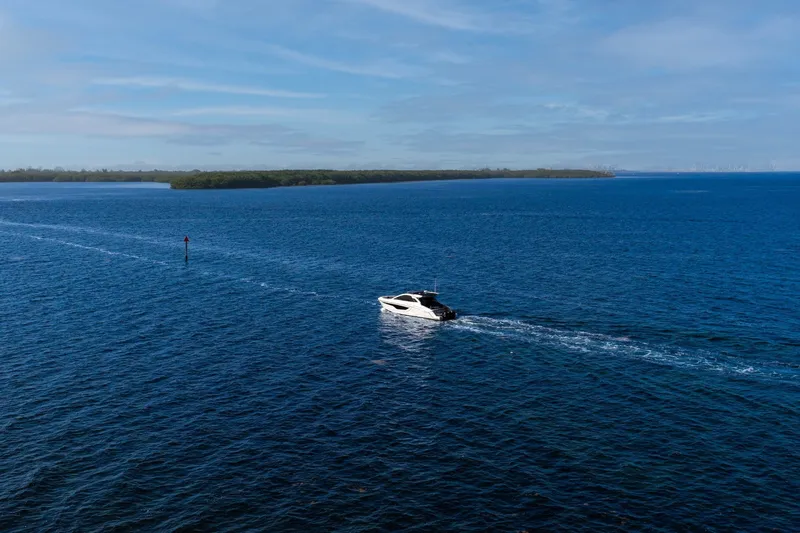 Slide: The Image of 2021 Cruisers Yachts 42 GLS OB cruising on open blue water under clear skies. - 33