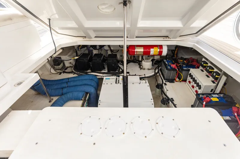 Slide: The Image of Engine compartment of 2021 Cruisers Yachts 42 GLS OB, showcasing batteries and fire extinguisher. - 25
