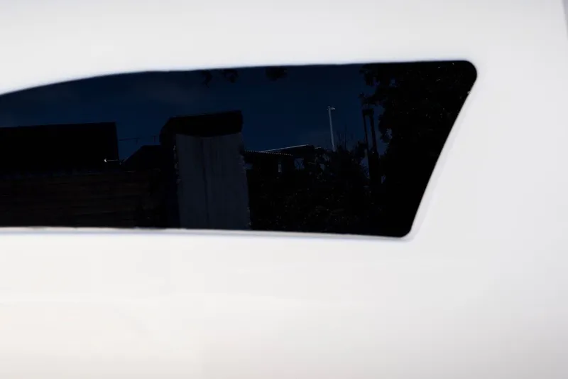 Slide: The Image of Close-up of a 2021 Cruisers Yachts 42 GLS OB window, reflecting a dark exterior scene. - 29