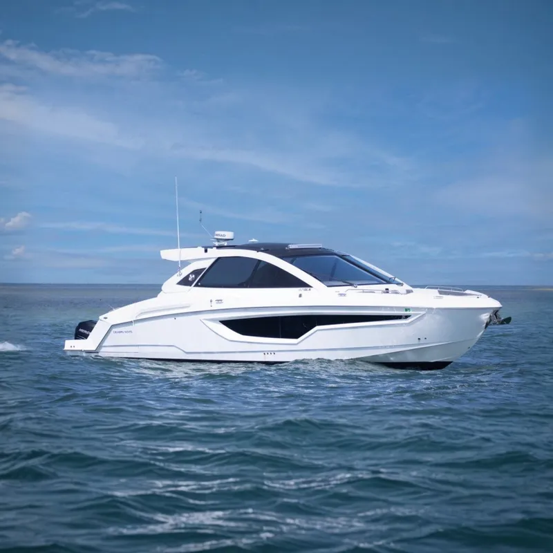 The Image of 2021 Cruisers Yachts 42 GLS OB on calm water under blue sky. - 0