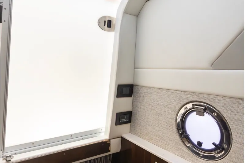 Slide: The Image of Interior of a 2021 Cruisers Yachts 42 GLS OB with a porthole and modern details. - 16