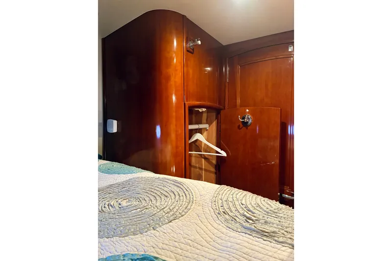 Slide: The Image of Luxurious wooden interior of 2004 Carver 570 Voyager Pilothouse with closet and bedding. - 35