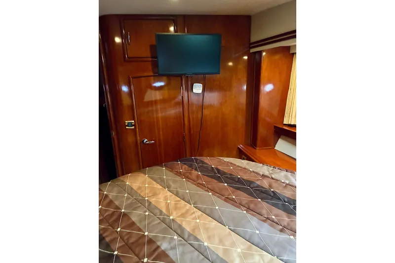 Slide: The Image of Interior of 2004 Carver 570 Voyager Pilothouse with TV and wood paneling. - 32