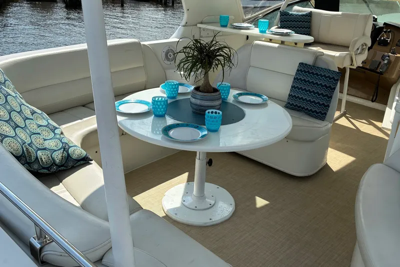 Slide: The Image of Luxurious 2004 Carver 570 Voyager Pilothouse yacht interior with elegant seating and dining setup. - 5