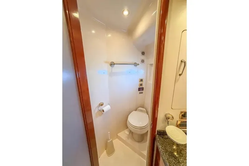 Slide: The Image of Compact bathroom in 2004 Carver 570 Voyager Pilothouse yacht, featuring toilet and granite countertop. - 21