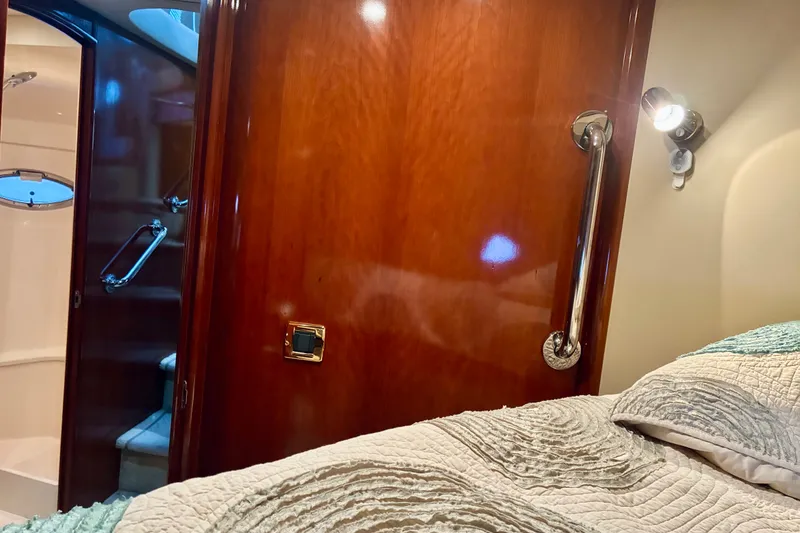 Slide: The Image of Interior of 2004 Carver 570 Voyager Pilothouse with wooden door and cozy bedding. - 36