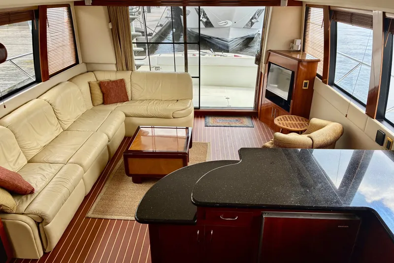 Slide: The Image of Luxurious interior of 2004 Carver 570 Voyager Pilothouse yacht with leather seating and elegant decor. - 12