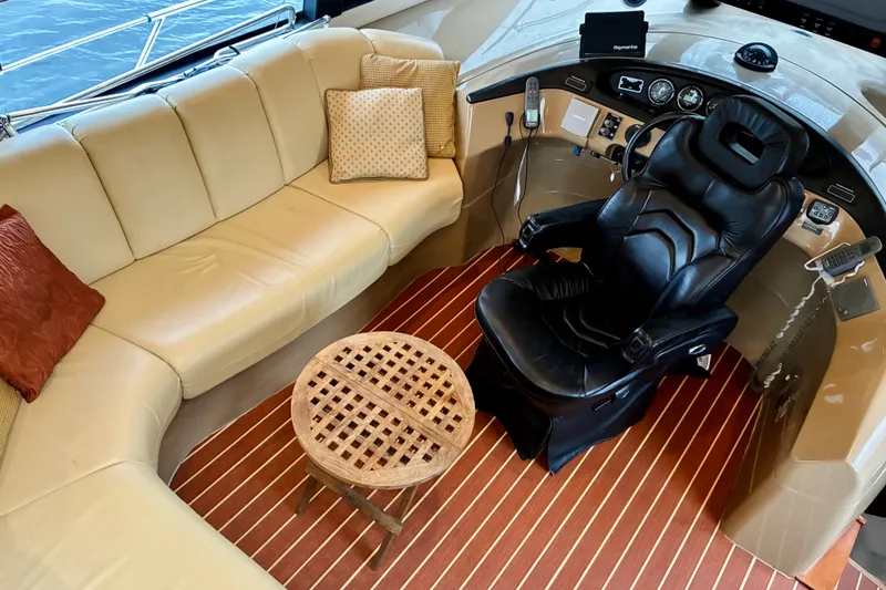 Slide: The Image of Luxurious 2004 Carver 570 Voyager Pilothouse interior with leather seating and captain's chair. - 29