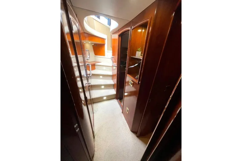 Slide: The Image of Interior hallway of 2004 Carver 570 Voyager Pilothouse with wooden cabinetry and carpeted stairs. - 14