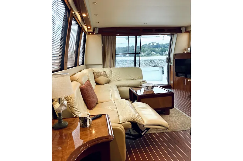 Slide: The Image of Luxurious interior of 2004 Carver 570 Voyager Pilothouse yacht with leather seating and scenic view. - 25