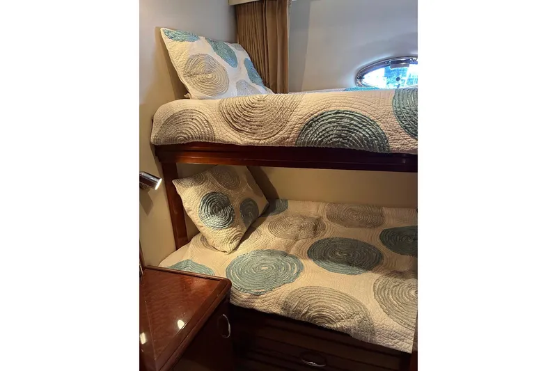 Slide: The Image of Bunk beds with patterned quilts in 2004 Carver 570 Voyager Pilothouse cabin. - 22