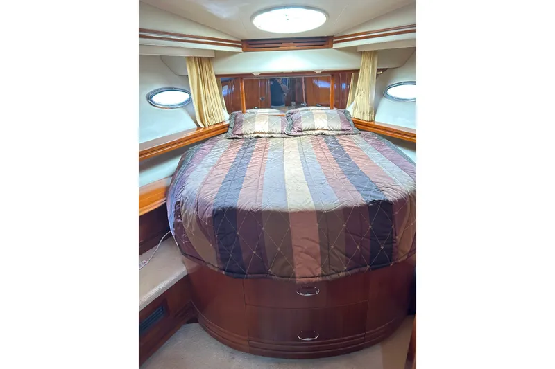 Slide: The Image of Luxurious bedroom interior of 2004 Carver 570 Voyager Pilothouse yacht with cozy bedding. - 17