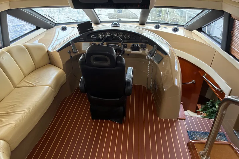 Slide: The Image of Luxurious 2004 Carver 570 Voyager Pilothouse interior with leather seating and modern helm. - 13