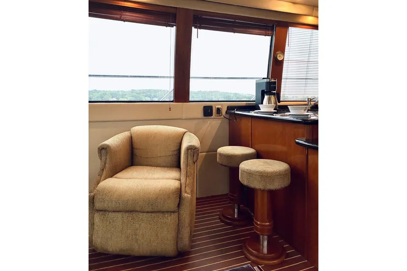 Slide: The Image of Interior of 2004 Carver 570 Voyager Pilothouse with cozy seating and bar stools. - 28