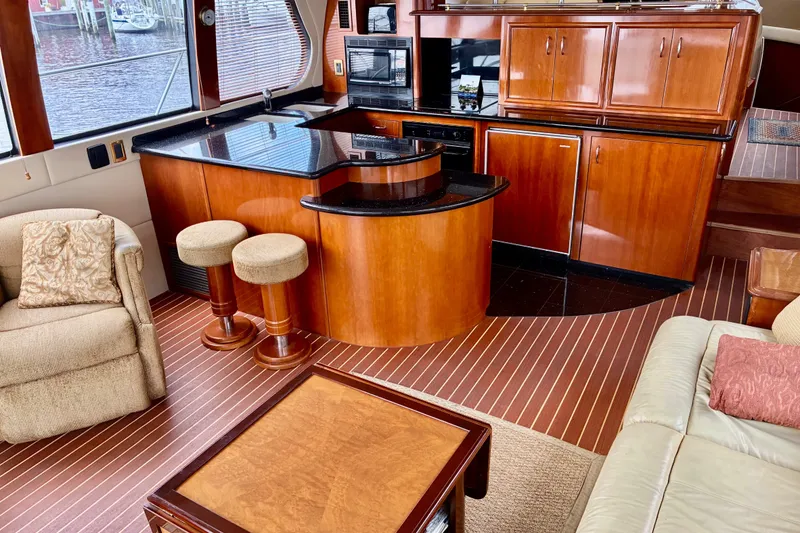 Slide: The Image of Luxurious interior of 2004 Carver 570 Voyager Pilothouse with elegant wood cabinetry and seating. - 10