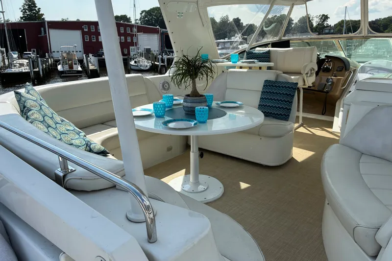 Slide: The Image of Luxurious 2004 Carver 570 Voyager Pilothouse yacht interior with elegant seating and dining area. - 4