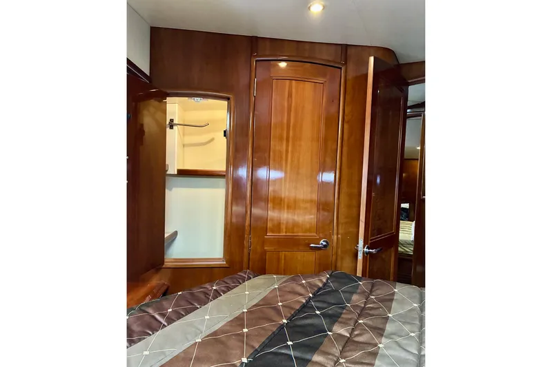 Slide: The Image of Interior of 2004 Carver 570 Voyager Pilothouse with wooden cabinetry and closet. - 30