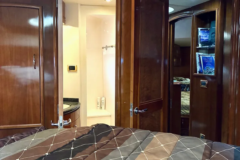 Slide: The Image of Luxurious interior of 2004 Carver 570 Voyager Pilothouse with wood finishes and cozy bedroom. - 31