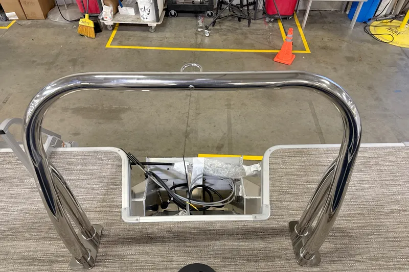Slide: The Image of Stainless steel railing on a 2027 Godfrey EX 2086 SBX boat in a workshop. - 9
