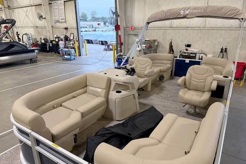 Slide: The Image of 2027 Godfrey EX 2086 SBX pontoon boat with beige seating in a warehouse setting. - 12