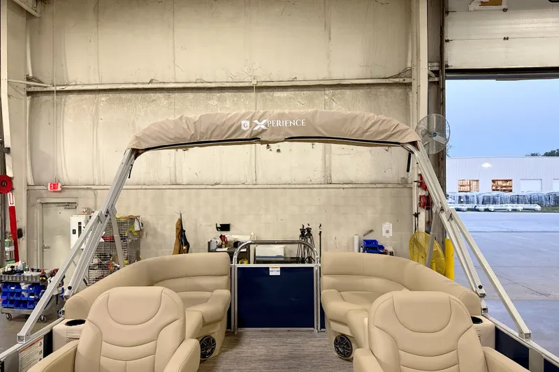 Slide: The Image of 2027 Godfrey EX 2086 SBX pontoon boat interior in a workshop setting. - 10