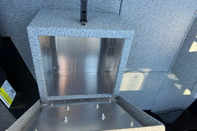 Slide: The Image of Open storage compartment in 2026 Crestliner 2050 Commander Elite boat, featuring metallic interior. - 18