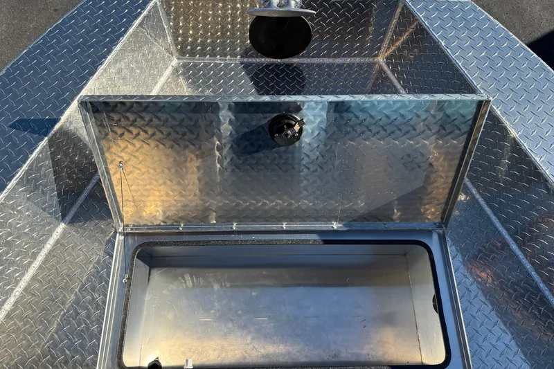 Slide: The Image of 2026 Crestliner 2050 Commander Elite boat storage compartment with diamond plate finish. - 5