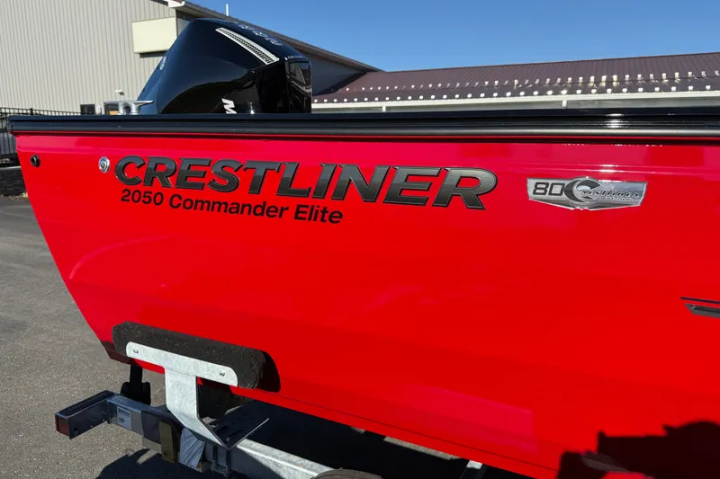 Slide: The Image of Red 2026 Crestliner 2050 Commander Elite boat on trailer, side view. - 2