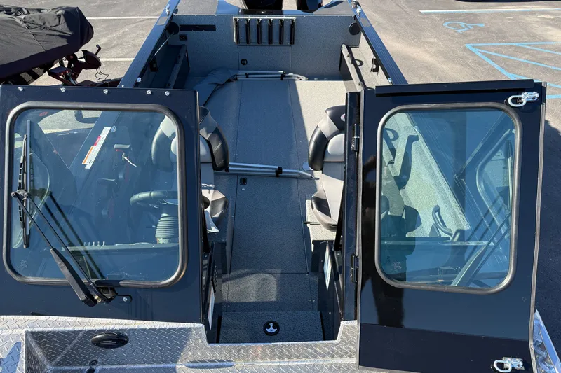 Slide: The Image of 2026 Crestliner 2050 Commander Elite boat interior with open doors and seating arrangement. - 7