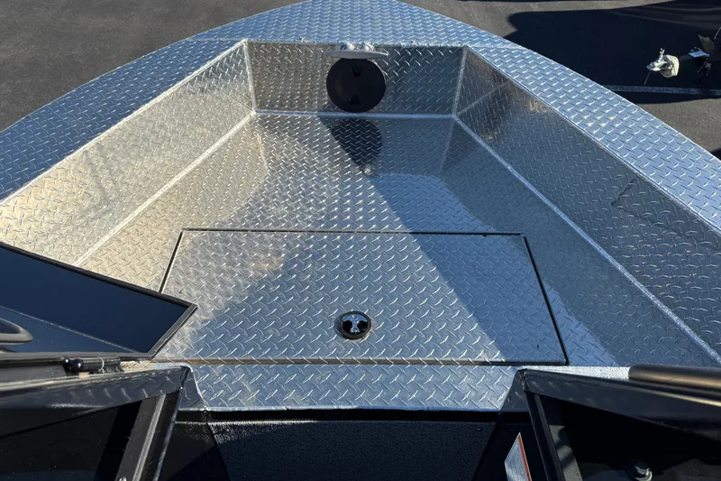 Slide: The Image of 2026 Crestliner 2050 Commander Elite boat with diamond plate flooring and storage compartment. - 4