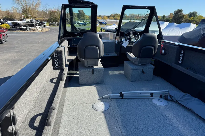 Slide: The Image of 2026 Crestliner 2050 Commander Elite boat interior with seating and steering wheel. - 17
