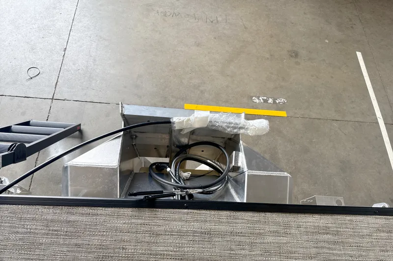 Slide: The Image of Overhead view of Godfrey EX 1880 CX boat components, 2027 model, in a workshop. - 12
