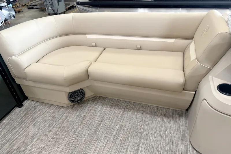 Slide: The Image of Luxurious seating on 2027 Godfrey EX 1880 CX boat, featuring beige upholstery and integrated speaker. - 5