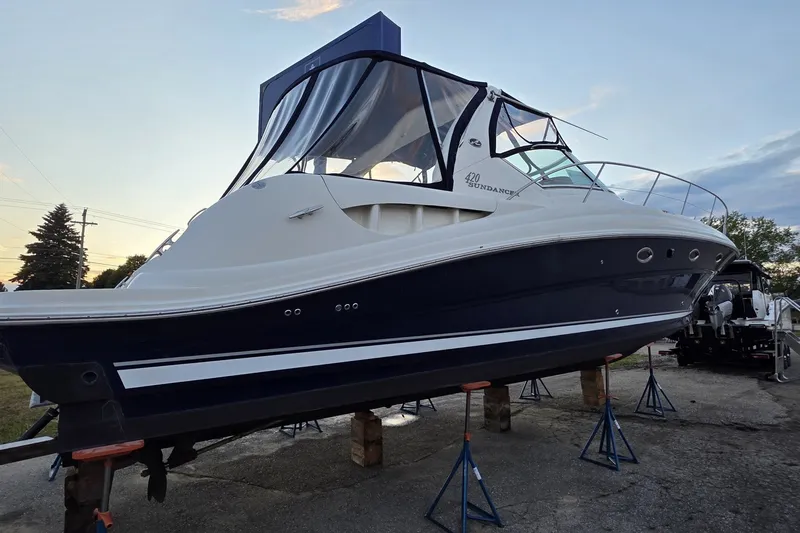 Slide: The Image of 2004 Sea Ray 420 Sundancer yacht on stands, showcasing sleek design and elegant curves. - 8