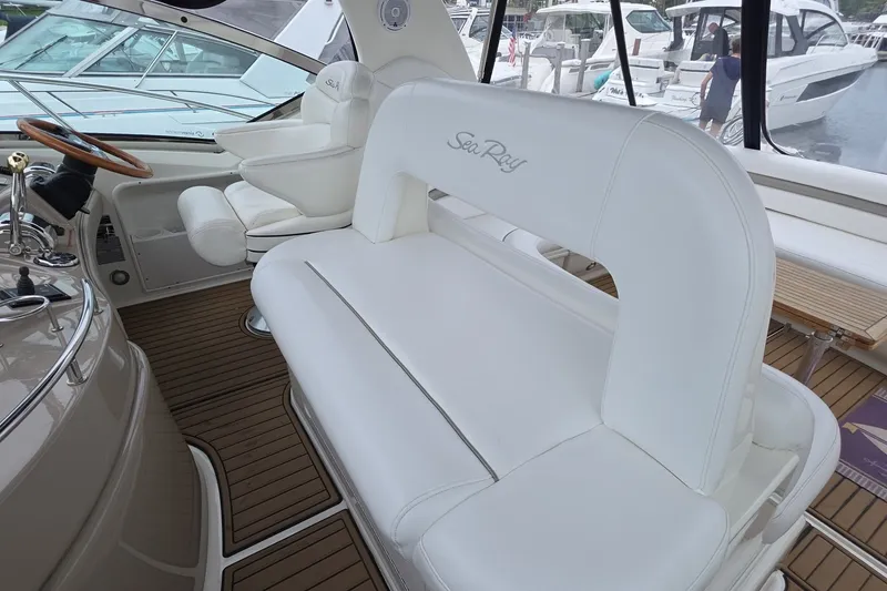 Slide: The Image of Luxurious 2004 Sea Ray 420 Sundancer yacht interior with white seating and wooden flooring. - 14