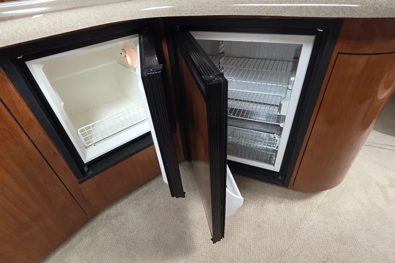 Slide: The Image of Interior view of a 2004 Sea Ray 420 Sundancer yacht with open refrigerator. - 29