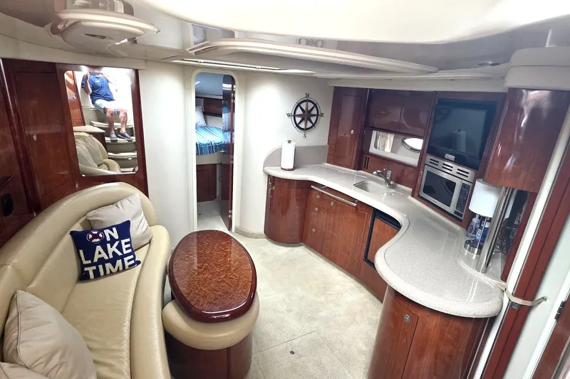 Slide: The Image of Luxurious interior of 2004 Sea Ray 420 Sundancer yacht with modern kitchen and cozy seating. - 34