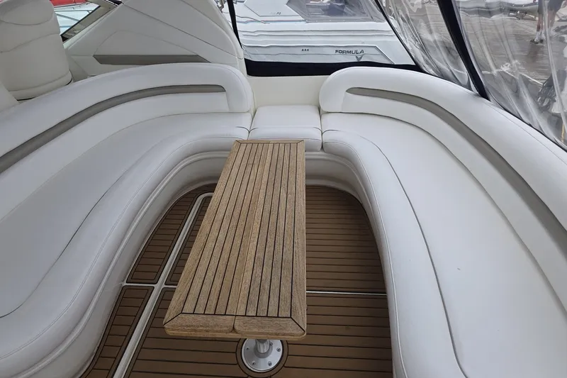 Slide: The Image of Luxurious seating area on a 2004 Sea Ray 420 Sundancer yacht with wooden table. - 15