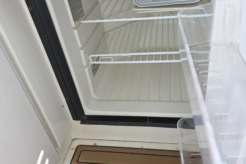 Slide: The Image of Empty refrigerator inside a 2004 Sea Ray 420 Sundancer yacht. - 17