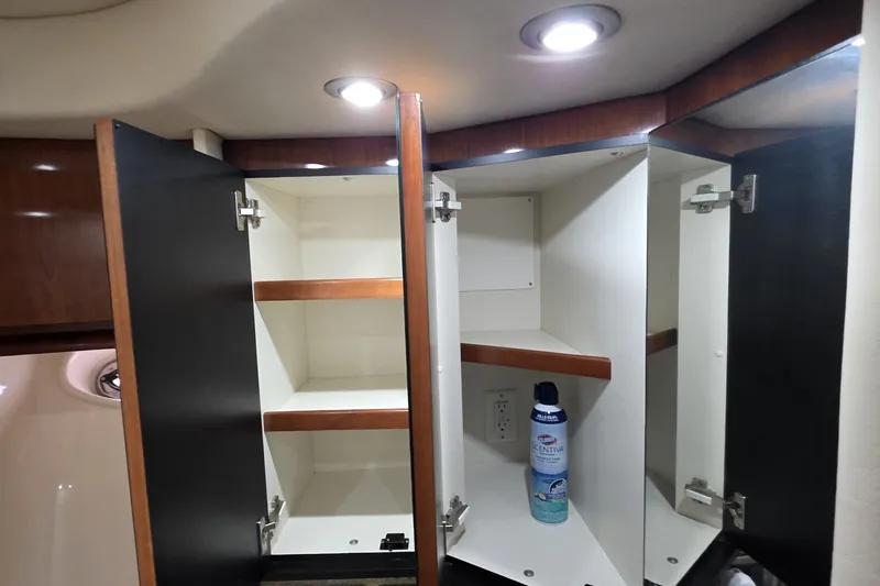 Slide: The Image of Open cabinet with shelves inside a 2004 Sea Ray 420 Sundancer yacht bathroom. - 32