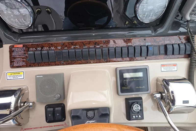 Slide: The Image of Control panel of a 2004 Sea Ray 420 Sundancer boat with gauges and switches. - 11